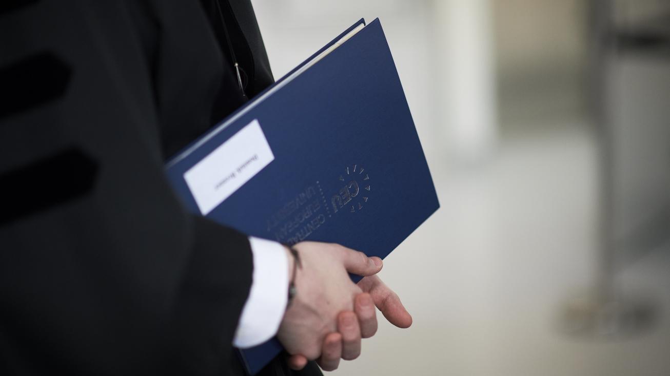 Close up on a diploma in a graduate's hands