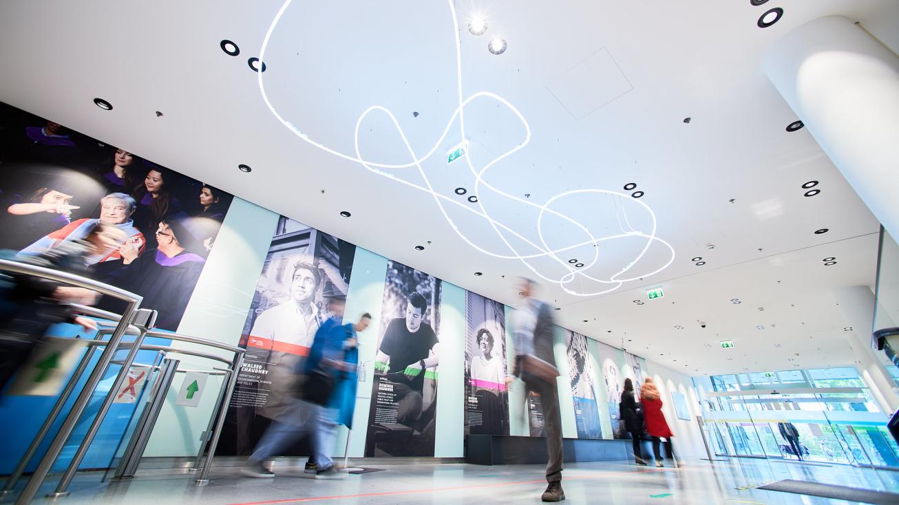People walking in the CEU Vienna campus lobby.