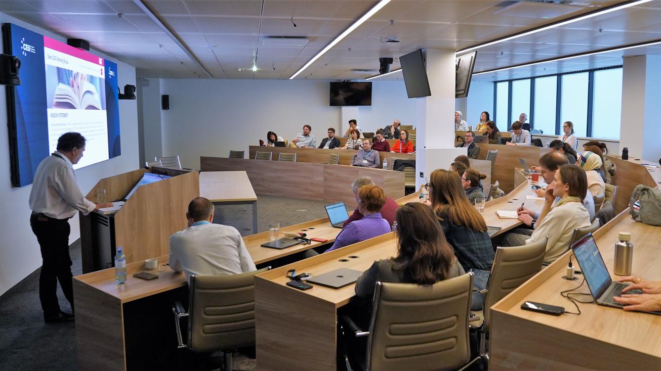 Peter B. Kaufman lecturing at the front of a full CEU classroom.